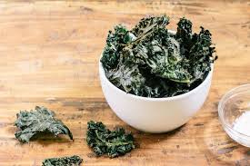 kale chips with parmesan cheese in a white bowl